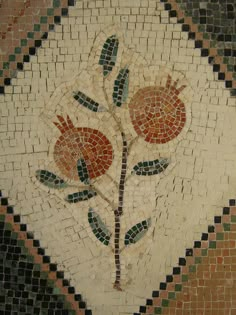 a mosaic design with two flowers on it