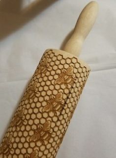 a wooden handle with honeycombs and bees on it