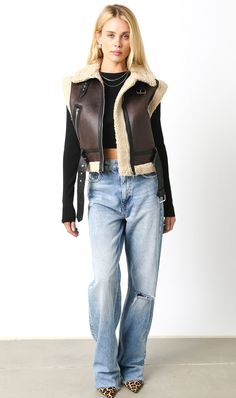 Faux leather vest with beige faux shearling trim Zipper front closure Belted waist Contrasting black faux leather Sleeveless 60% Polyurethane, 40% Polyester Leather Sherpa Vest Outfit, Aviator Vest Outfit, Sheepskin Vest Outfit, Shearling Vest Outfit, Sherpa Vest Outfit, Fur Outfit, Vest Outfits For Women, Faux Leather Vest, Vest Outfit