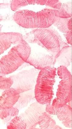 pink lipstick kisses are arranged in the shape of an abstract pattern on a white background