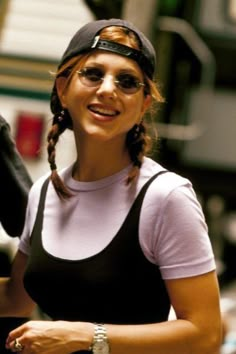 a woman wearing sunglasses and a baseball cap