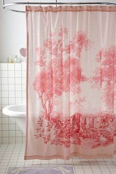 a bathroom with a shower curtain that has pink trees on it and white tile flooring