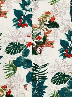 a white shirt with green leaves and red berries on it