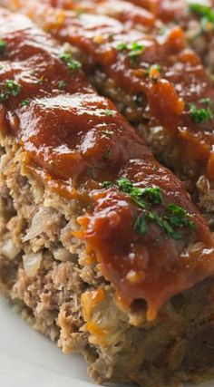 meatloaf on a plate with sauce and parsley