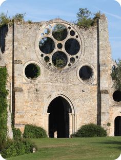 an old stone building with round windows