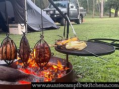 an open fire pit with food cooking on it