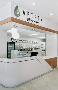 a pharmacy store with an apple logo on the wall and shelves in front of it