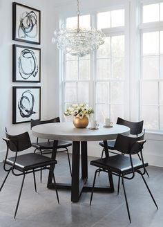 a dining room table with four chairs around it