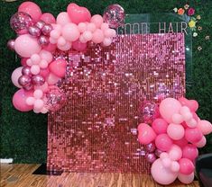 pink balloons and sequins are on display in front of a backdrop