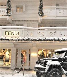 a car parked in front of a building covered in snow