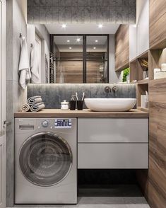 a washer and dryer in a bathroom with wood paneling on the walls