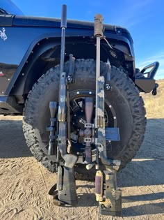 an off road vehicle is parked in the sand with its tire on it's side