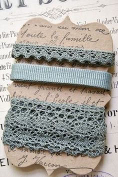 three crocheted hair ties on top of a piece of paper with an old book in the background