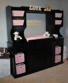 a baby crib with pink and black decor