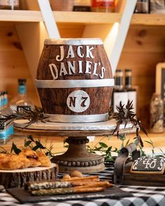 there is a wooden barrel with jack daniels written on it and other items around it