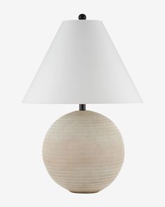 a table lamp with a white shade on the base and a light bulb attached to it