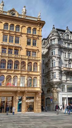 people are walking around in front of some buildings