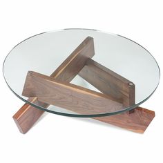 a glass and wood coffee table with two pieces of wood on the bottom, sitting in front of a white background