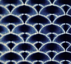 an abstract blue and white background with circles in the shape of fish scales on top of each other