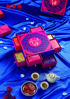 an assortment of teas and condiments on a blue tablecloth with red boxes