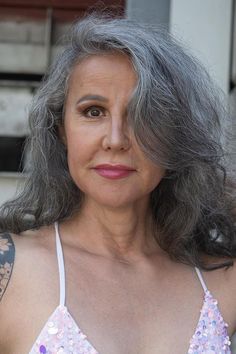 This hairstyle displays the natural beauty of gray hair, flowing in gentle curves that add fullness and a small amount of refinement. The hair rests lightly on the shoulders, emphasizing a sense of elegance and timeless appeal for women over 60 who prefer a longer, more feminine appearance. Its feel and flow make it - Click to see more of Timeless and Chic: 40 Hairstyle Ideas for Women in their 60s and follow us for more hairstyle ideas. // Photo Credit: Instagram @brigitte_steinmeyer_official Hair Flowing, Silver Foxes, Natural Waves