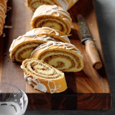 sliced cinnamon roll sitting on top of a wooden cutting board