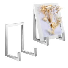 two metal frames with dried flowers in them