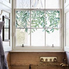 a bathroom with a sink, window and towel rack