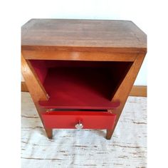 a wooden table with red drawers on it