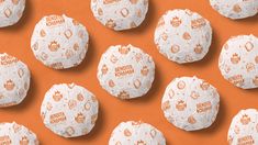 several balls of bread are arranged on an orange background