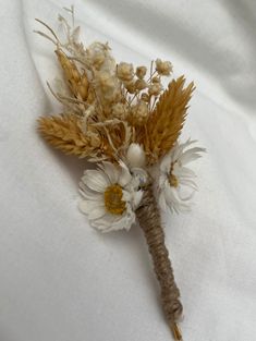 a dried flower on a white cloth