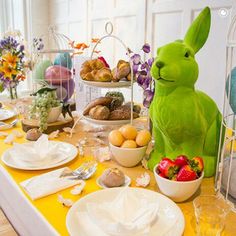 the table is set with plates, bowls and utensils for an easter meal