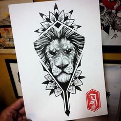 a hand holding up a card with a drawing of a lion's head on it