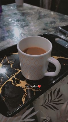 a cup of coffee sitting on top of a tray