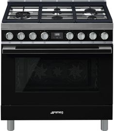 an electric stove with four burners and two oven doors on the front, in stainless steel