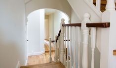 the stairs in this house are white and wood