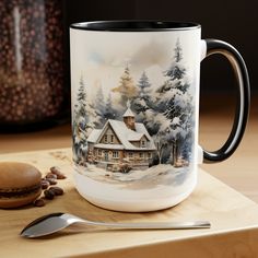 a coffee mug sitting on top of a wooden table next to a spoon and cup