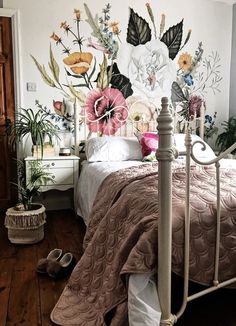 a bedroom with floral wallpaper and white bedding