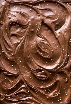 a close up view of chocolate frosting on top of it's icing