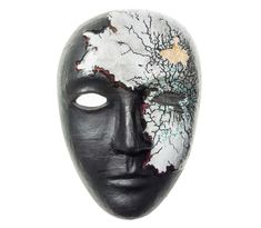 a black mask with white flowers on it