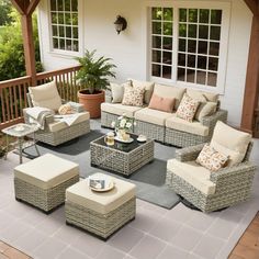 an outdoor patio with wicker furniture and potted plants