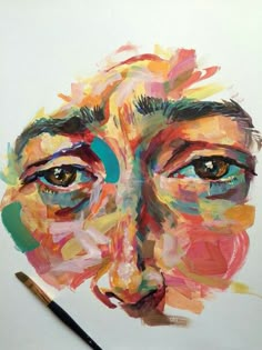 a painting of a woman's face with colorful paint strokes on it and a pencil in the foreground