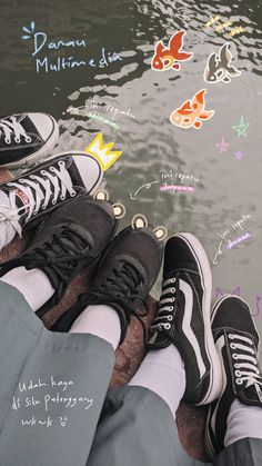 two people sitting next to each other with their feet in the water and writing all over them