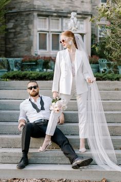 a bride and groom are sitting on the steps