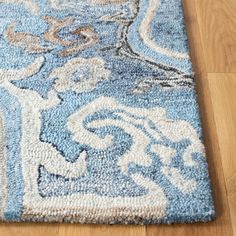 a blue and white rug on the floor