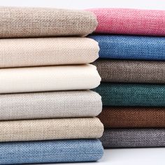 a stack of different colored linens sitting on top of each other