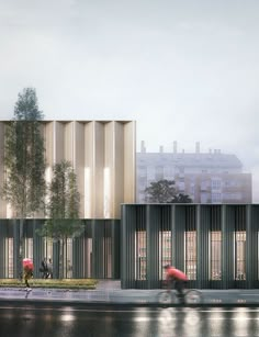 two people are walking on the sidewalk in front of a building with vertical striped walls