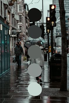 people walking down the street with umbrellas on a rainy day