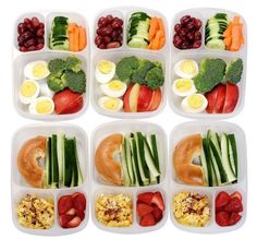 six plastic trays filled with different types of vegetables and fruits in each one, including eggs, cucumbers, strawberries, broccoli, grapes, celer