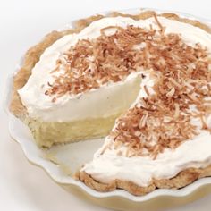 a pie with white frosting and toasted coconut on top